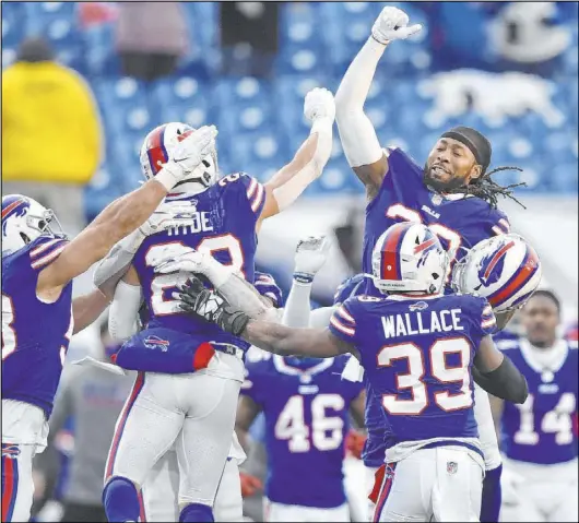  ?? Adrian Kraus The Associated Press ?? Buffalo players celebrate Micah Hyde’s (23) defensive play to preserve the Bills’ 27-24 win against Indianapol­is.