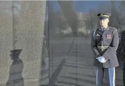  ?? AP FILE PHOTO ?? HONOR ROLL: An honor guard stands next to the Vietnam Veterans Memorial wall in Washington, D.C.