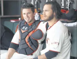  ?? STAFF FILE PHOTO ?? The Giants’ Buster Posey, left, and Brandon Crawford relax in the dugout during a 2014 game against the Washington Nationals at AT&T Park in San Francisco.