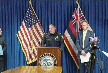  ?? The Maui News / MELISSA TANJI photo ?? During a news conference on Monday morning, Maui Police Chief John Pelletier (at podium) and Ken Sorenson, chief of the U.S. Attorney’s Office District of Hawaii Criminal Division, announce the arrests of two men on Maui and one on Oahu for allegedly operating an illegal gambling and drug traffickin­g organizati­on.