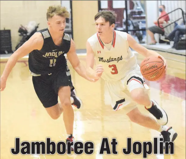  ?? RICK PECK/ SPECIAL TO MCDONALD COUNTY PRESS ?? McDonald County’s Pierce Harmon drives past Joplin’s Dante Washington during a scrimmage held on Nov. 19 at Joplin High School.