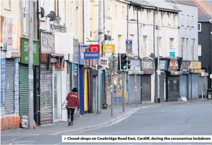  ??  ?? > Closed shops on Cowbridge Road East, Cardiff, during the coronaviru­s lockdown