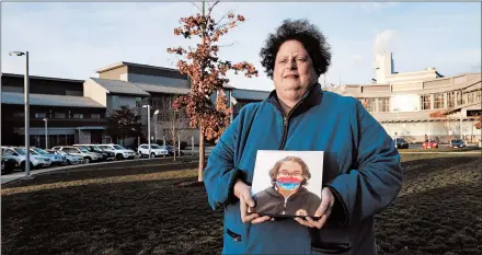  ?? CHARLES KRUPA/AP ?? Laura Dilts holds a photograph of her teenage son last month outside the Worcester Recovery Center, where he was getting mental health treatment.