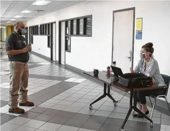  ?? Courtesy San Jacinto College ?? Ali Shah, left, San Jacinto College director of emergency management, checks in with Diane Zerbe, department chair for medical imaging, to make sure altered operations are running smoothly.