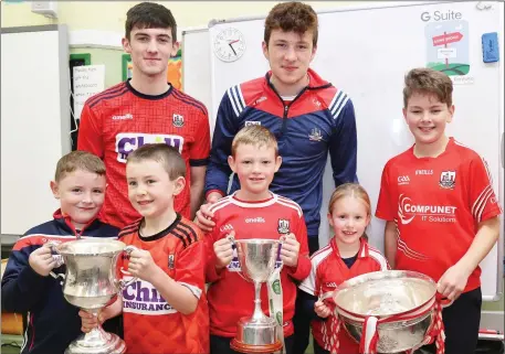  ??  ?? Olan Keohane, Aaron Dugdale, Aaron Breen, Abbie Browne and Eoghan Moynihan pictured with Cork All Ireland Minor Team winners Thomas Casey and Luke Murphy during their visit to Boherbue National School. Photo by Sheila Fitzgerald