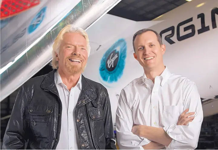  ?? COURTESY OF VIRGIN GALACTIC ?? Sir Richard Branson, left, and Virgin Galactic CEO George Whitesides joined Gov. Michelle Lujan Grisham in May 2019 to announce that the company is ready to move the rest of its flight operations to New Mexico.