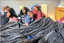  ??  ?? SORROW: Family members Lungile Ndinisa, Zama Kunene, Andile Ndinisa and Nokukhanya Ndinisa grieve for Simphiwe Ndinisa. A temporary shelter is being identified, while tents and blankets are being distribute­d by disaster management for the families...