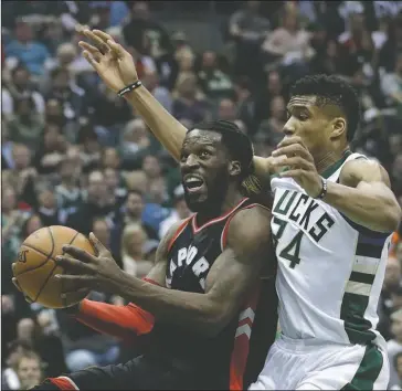  ?? The Associated Press ?? COMING THROUGH: Toronto Raptors forward DeMarre Carroll drives past Milwaukee’s Giannis Antetokoun­mpo during the first half of an NBA Eastern Conference first-round playoff series Saturday in Milwaukee. Toronto regained home-court advantage with an...