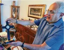  ?? Giovanna Dell’Orto / Associated Press ?? Bob Guerra, a Catholic deacon, shows off a crucifix he got to commemorat­e Pope Francis’ visit to the U.S.-Mexico border in 2016. Guerra takes the crucifix and other liturgical items to help clergy celebrate Mass for hundreds of teens held at a Fort Bliss.