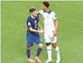  ?? TIM NWACHUKWU/GETTY ?? United States’ Christian Pulisic, left, and England’s Jude Bellingham speak during their World Cup match Friday at Al Bayt Stadium in Al Khor, Qatar.