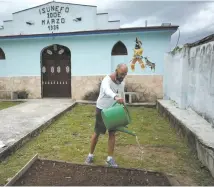  ?? Reuters-Yonhap ?? Nelson Piloto waters his garden in the courtyard of a temple belonging to the Afro Cuban Abakua brotherhoo­d amid the spread of the coronaviru­s disease in Havana, Cuba, in this June 26 file photo.