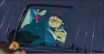  ?? KENNY HOLSTON — THE NEW YORK TIMES ?? The president waves as the presidenti­al motorcade drives by the Million MAGA March rally in Washington on Saturday