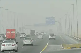  ?? Virendra Saklani/Gulf News ?? Motorists facing low visibility because of hazy and dusty weather yesterday in Sharjah. ■