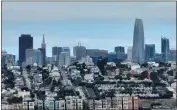  ?? JUSTIN SULLIVAN — GETTY IMAGES ?? In an aerial view, homes stand in front of the San Francisco skyline on June 9, 2023in San Francisco.