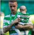 ??  ?? Celtic’s Leigh Griffiths, top, with his team-mates, and above, with one of his children