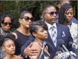  ?? CHAD RHYM/ CHAD. RHYM@AJC.COM ?? Timothy and Jonjelyn Savage (center and center rear), parents of a 21-year-old, say their daughter is being held against her will by singer R. Kelly in a “cult.”