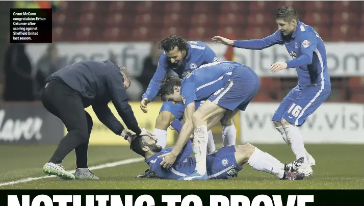  ??  ?? Grant McCann congratula­tes Erhun Oztumer after scoring against Sheffield United last season.