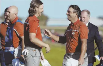  ?? AP PHOTO ?? CAN’T BE BEAT: Europe’s Francesco Molinari (right) and Tommy Fleetwood celebrate after beating Tiger Woods and Bryson DeChambeau yesterday at the Ryder Cup in Saint-Quentin-en-Yvelines, France. Fleetwood and Molinari are 4-0.