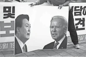  ?? LEE JIN-MAN/AP ?? A banner featuring U.S. President Joe Biden, right, and South Korean President Yoon Suk Yeol is prepared Thursday for a Progressiv­e Party rally demanding the withdrawal of the government’s anti-north Korea policies.