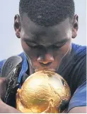  ??  ?? Paul Pogba kisses the World Cup
