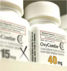  ??  ?? Bottles of prescripti­on painkiller OxyContin pills, made by Purdue Pharma LP sit on a counter at a local pharmacy in Provo, Utah. — Reuters photo