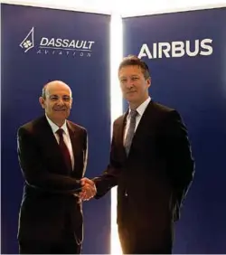  ??  ?? FORGING TIES: ÉRIC TRAPPIER, CHAIRMAN AND CEO OF DASSAULT AVIATION, AND DIRK HOKE, CHIEF EXECUTIVE OF AIRBUS DEFENSE AND SPACE AT THE BERLIN AIRSHOW, GERMANY, IN APRIL 2018