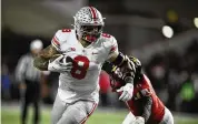  ?? NICK WASS / AP ?? Ohio State tight end Cade Stover (8) runs with the ball past Maryland linebacker Ruben Hyppolite II (11) during the second half of their game on Nov. 19, 2022. Stove was a team captain last season and figures to be one again in 2023.