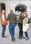  ?? JACQUELYN MARTIN / AP ?? Staff members of House Speaker Nancy Pelosi, including Pelosi’s Chief of Staff Terri McCullough, second from right, hug outside of the Capitol on Friday before entering a vehicle on Capitol Hill in Washington.