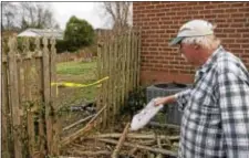  ?? RICK KAUFFMAN — DIGITAL FIRST MEDIA ?? Ed Young, 65, gestures with a newspaper how firefighte­rs chopped down a rear fence to release two police officers who rescued a woman from the home early Friday morning.