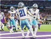  ?? ADAM BETTCHER/GETTY ?? Ezekiel Elliott celebrates with QB Dak Prescott after rushing for a touchdown in the Cowboys’ 40-3 rout of the Vikings on Sunday in Minneapoli­s.