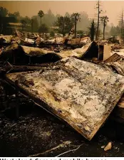 ??  ?? Wasteland: Cars and mobile homes reduced to burnt-out hulks in Santa Rosa