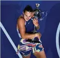  ?? Ng Han Guan / Associated Press ?? Aryna Sabalenka hugs the Daphne Akhurst Memorial Trophy after defeating Elena Rybakina in the women’s singles final at the Australian Open on Saturday.