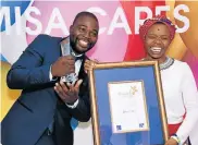  ??  ?? THE WINNER IS: Zukiswa Sithole and her husband Paul celebrate her accolade at the Indaba Hotel in Johannesbu­rg