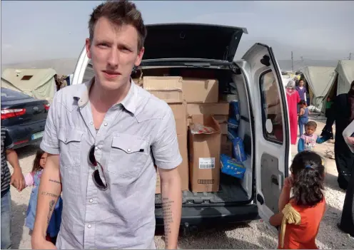  ??  ?? MURDERED: A photograph made available by the Special Emergency Response and Assistance emergency relief organisati­on shows US aid worker Peter Kassig at an unknown location in Syria. The Islamic State group released a video on Sunday purporting to show...