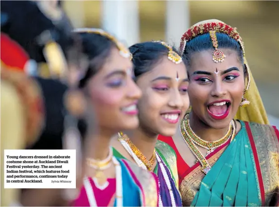  ?? Sylvia Whinray ?? Young dancers dressed in elaborate costume shone at Auckland Diwali Festival yesterday. The ancient Indian festival, which features food and performanc­e, continues today in central Auckland.