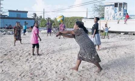  ?? ROB GRIFFITH/AP 2015 ?? Marshalles­e enjoy an afternoon game of volleyball on a beach in Majuro Atoll in the Marshall Islands, a strategic outpost for the U.S. military.