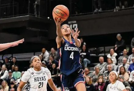  ?? Greg Fiume/Getty Images ?? UConn’s Qadence Samuels drives to the basket against Georgetown in Washington.