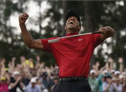  ?? DAVID J. PHILLIP - THE ASSOCIATED PRESS ?? In this April 14, 2019 file photo, Tiger Woods reacts as he wins the Masters golf tournament in Augusta, Ga. Woods’ victory at the Masters might not have been the most important sports story of 2019.