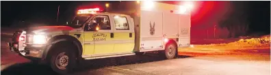  ?? CP ?? An emergency vehicle blocks the highway Friday night after the fatal bus-truck crash south of Nipawin, Sask.