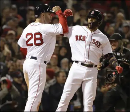 ?? DAVID J. PHILLIP - THE ASSOCIATED PRESS ?? Boston Red Sox’s Eduardo Nunez celebrates with J.D. Martinez, left, after hitting a three-run home run during the seventh inning of Game 1 of the World Series baseball game against the Los Angeles Dodgers Tuesday, Oct. 23, 2018, in Boston.