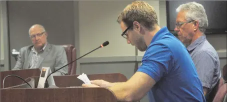  ?? Photo by Matthew Liebenberg ?? The Center Executive Director Nathan Wiebe speaks during the public hearing, Aug. 27. Seated behind him is Pastor Kevin Snyder of the East Side Church of God.