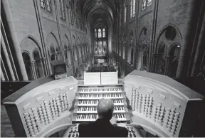  ?? [ASSOCIATED PRESS FILE PHOTO] ?? In May of 2013, Philippe Lefebvre, 64, played the organ at Notre Dame Cathedral in Paris. The organ is being taken apart and painstakin­gly cleaned in a process that likely will take four years.