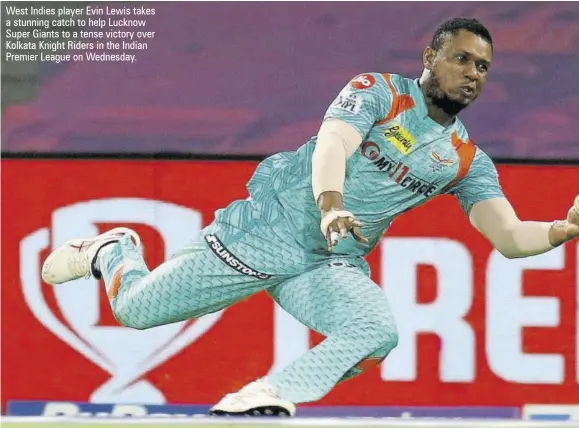  ?? ?? West Indies player Evin Lewis takes a stunning catch to help Lucknow Super Giants to a tense victory over Kolkata Knight Riders in the Indian Premier League on Wednesday.