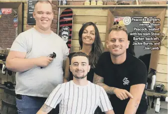  ??  ?? Peacocks Barbers owner Shaun Peacock, seated, with his team Steve Barker, back left, Jackie Burns, and Joe Lamb.