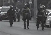  ?? TRIBUNE NEWS SERVICE ?? Police moved to clear a group of protesters near the Minneapoli­s Police Fifth Precinct about a half-hour after curfew Saturday.