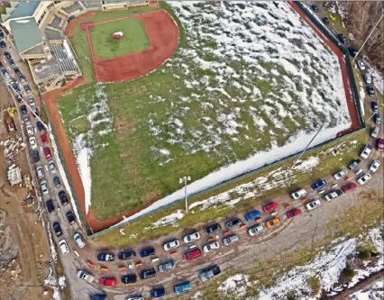  ?? Matt Freed/Post-Gazette ?? Cars line up for a two-hour wait for free COVID-19 testing at Michelle Krill Memorial Field at Pullman Park on Friday in Butler.