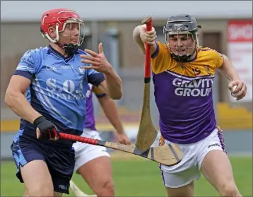  ??  ?? Cormac Byrne (Faythe Harriers) shakes off the challenge of Liam Rochford (St. Anne’s).