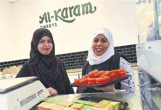  ?? KARON LIU TORONTO STAR ?? Anum Butt, left, and Sabahat Beg work at Al-Karam Sweets in Scarboroug­h, where South Asian sweets are made in house.