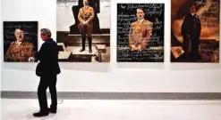  ??  ?? A visitor walks past artworks by Polish-US artist Piotr Uklanski and US artists McDermott & McGough, at the National museum of Contempora­ry Art in Athens.