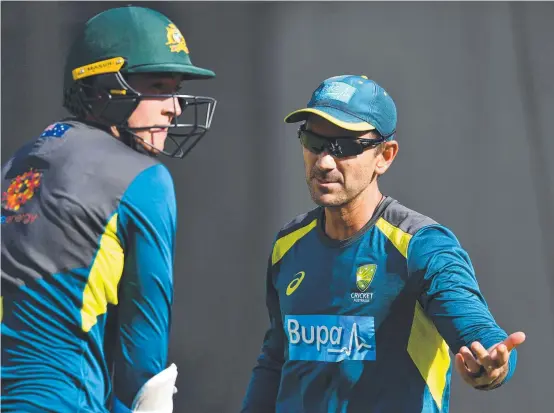  ??  ?? TOUGH JOB: Australian coach Justin Langer (left) talking to Matt Renshaw at a recent training session.